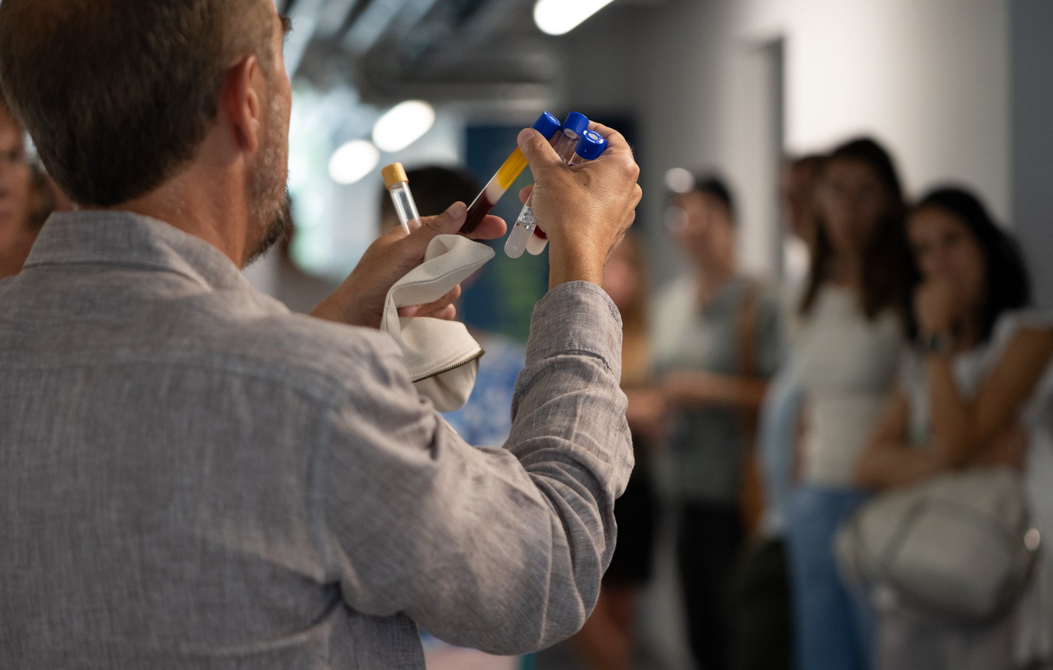 RegenLab specialist showing PRP tubes to clinicians